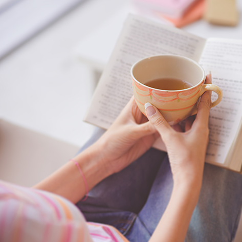 2 – Woman with cup of tea and book